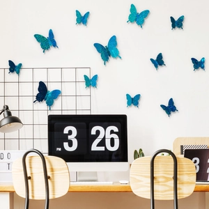 Detailed close-up of blue glitter 3D butterfly wall stickers in a modern office interior