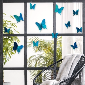 Blue 3D glitter butterfly wall decals for home decor shown on indoor green plants