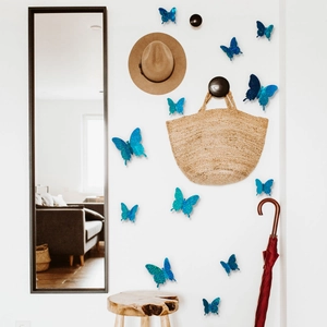 Detail of 3D blue glitter butterfly wall stickers set in a home interior scene
