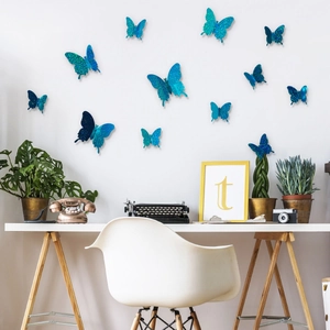 Blue glitter 3D butterfly wall stickers in a vintage office setting with green plants