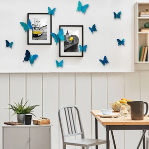 3D glittery blue butterfly wall stickers displayed as decor in a modern dining room setting