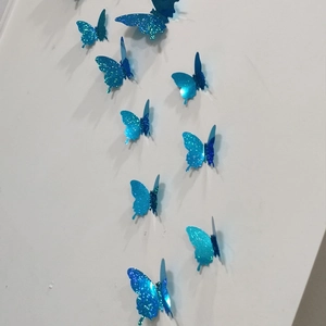 Detail of 3D royal blue glitter butterfly wall stickers showing realistic 3D folding effect
