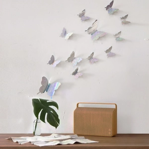 Macro detail of 3D iridescent silver butterfly wall stickers with shimmering texture