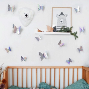 Holographic 3D butterfly wall stickers in a cozy nursery room with a wooden crib