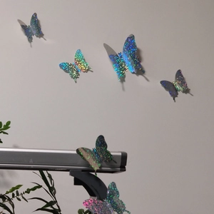 Detail of 3D holographic butterfly wall decals with sparkling glitter finish for home decor