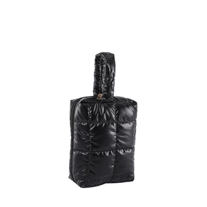 Minimalist black quilted puffer handbag with glossy finish and top zipper handle