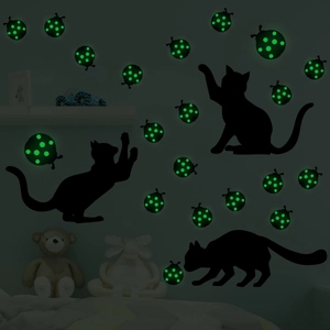 Glow-in-the-dark wall stickers showing black cat silhouettes and luminous green ladybugs