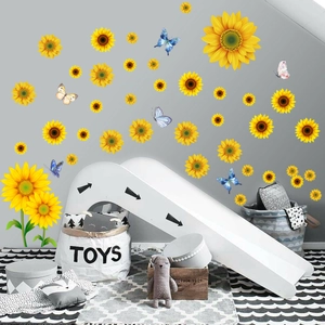 Detail showing colorful sunflower wall decals and butterfly stickers in a cozy nursery room