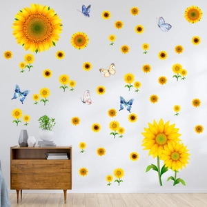 Detail of sunflower and butterfly wall decals on a white wall above a wooden cabinet