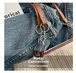 Detailed close-up of woven tote bag with silver metal chain links and brown handle