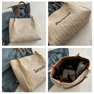Close-up of straw tote bag showing Summer embroidery, leather strap and spacious interior