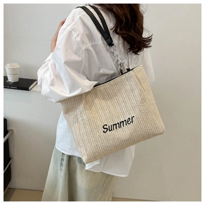 Detail of Summer letter embroidery on woven tote with leather chain shoulder straps