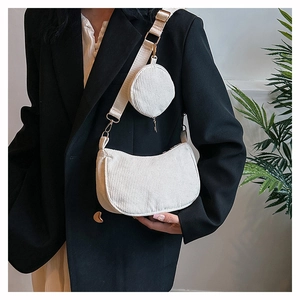 Detail of corduroy crescent bag with matching round coin purse and wide fabric strap