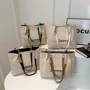 Set of four woven straw tote bags with Summer embroidery and chain straps