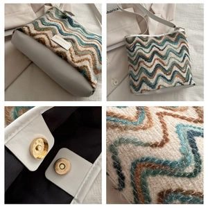 Detail of wave pattern knit fabric and magnetic metal clasp on the large bucket bag
