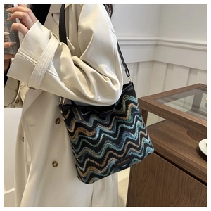 Detail of colorful bohemian wave pattern woven texture on casual bucket bag