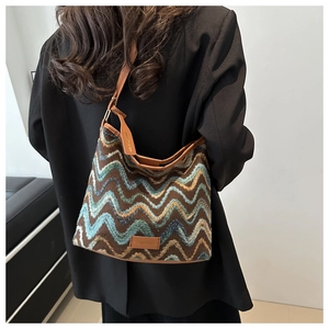 Detail of wool tote bag featuring retro brown base and vibrant wavy zigzag patterns