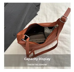 Internal view of the brown leather tote bag showing spacious capacity and silver hardware
