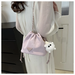 Detail der lavendelfarbenen Beuteltasche mit Kette und flauschigem Monster-Anhänger