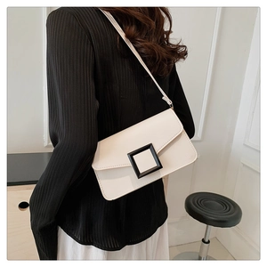 Back view of a model wearing a white crossbody bag with a bold black buckle accent