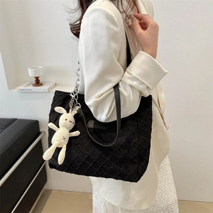 Large black pleated tote bag with leather straps and cute bunny charm accessory