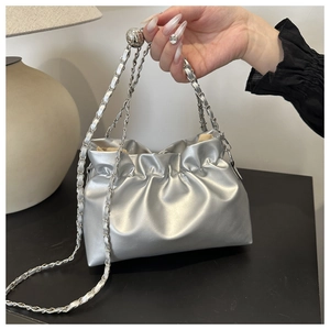 Detail of silver metallic pleated bag with decorative metal ball chain strap