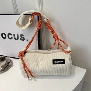 White corduroy barrel shoulder bag with orange woven rope strap and fashion label