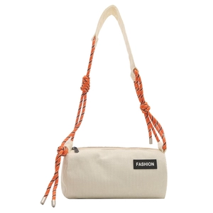 Minimalist beige corduroy cylinder crossbody bag with tricolor rope strap and fashion tag
