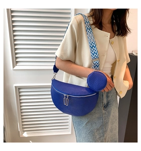 Detail of blue crescent saddle bag with textured leather and geometric wide strap