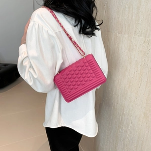 Pink crossbody bag with embossed texture and gold chain strap in French style