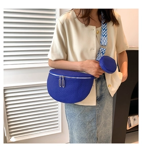 Detail of bright blue crescent crossbody bag with ethnic style strap and mini coin purse