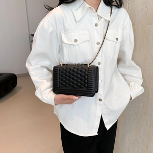 Chic black quilted chain crossbody bag with bubble texture and woven metal strap