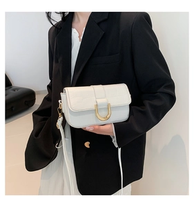 Borsa a tracolla bianca effetto coccodrillo con fibbia a D dorata su blazer nero