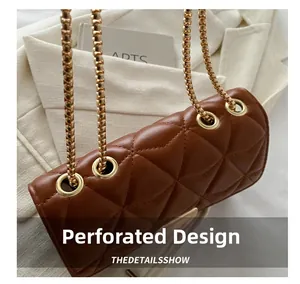 Close-up of brown quilted leather bag featuring gold eyelets and chain strap detail