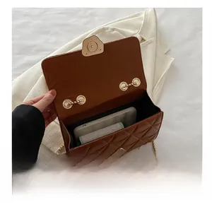 Top view of brown quilted crossbody bag showing spacious interior compartment for phone