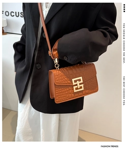 Crocodile pattern brown leather bag with gold geometric lock and adjustable strap