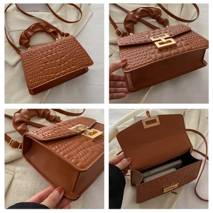 Detailed views of brown crocodile pattern square bag with gold buckle and ruched handle