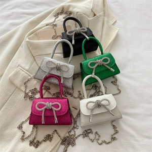 Mini crossbody bags in five colors with glitter finish and rhinestone bow details