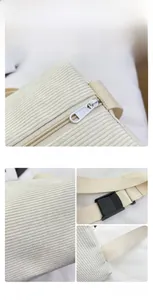 Detail view of corduroy shoulder bag showing zipper, fabric texture, and strap buckle