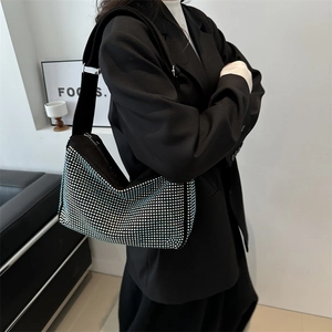 Chic black tote bag with sparkling blue rhinestones and a wide shoulder strap