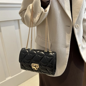 Classic black quilted chain bag with gold lock buckle and dual metal shoulder straps