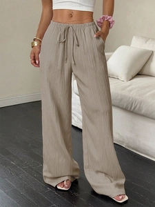Detail showing the elastic drawstring high waist and pleated texture of these wide leg pants