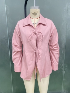 Détails du chemisier rose à manches longues avec tissu texturé et attaches à nœuds