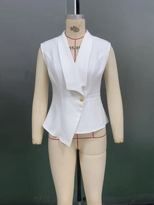 Detail of white waistcoat featuring asymmetric lapels and a single gold button closure