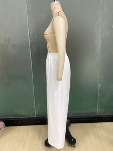 Detail view of white wide-leg trousers featuring an elastic high waist and straight cut