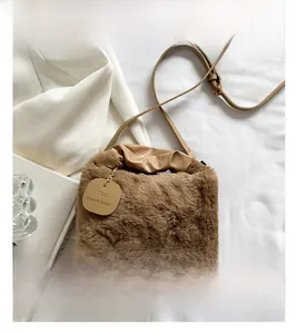 Detail of plush brown faux fur shoulder bag with tag and stylish PU leather handle