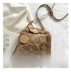 Detailed view of a brown faux fur mini crossbody bag with leather strap and size reference
