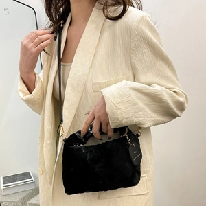 Chic black plush shoulder bag for women with gold chain strap and soft faux fur texture
