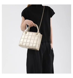 Close-up of champagne gold quilted chain handbag with elegant diamond lattice pattern