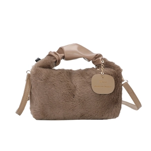 Brown plush shoulder bag with pleated leather handle and gold lettering charm